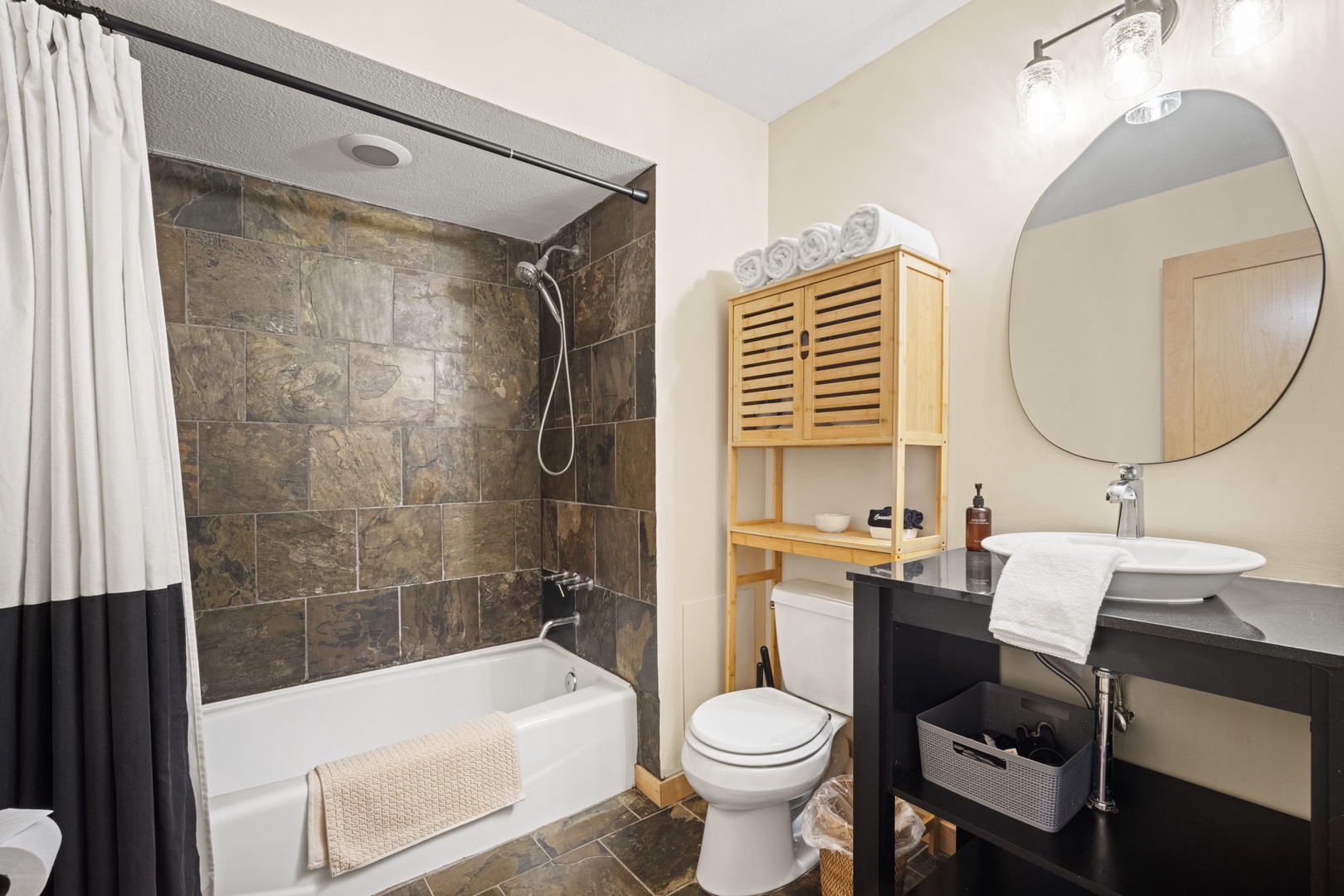 Unwind in your private bathroom with a sleek tub-shower combo, crisp linens, and modern fixtures designed for your comfort.