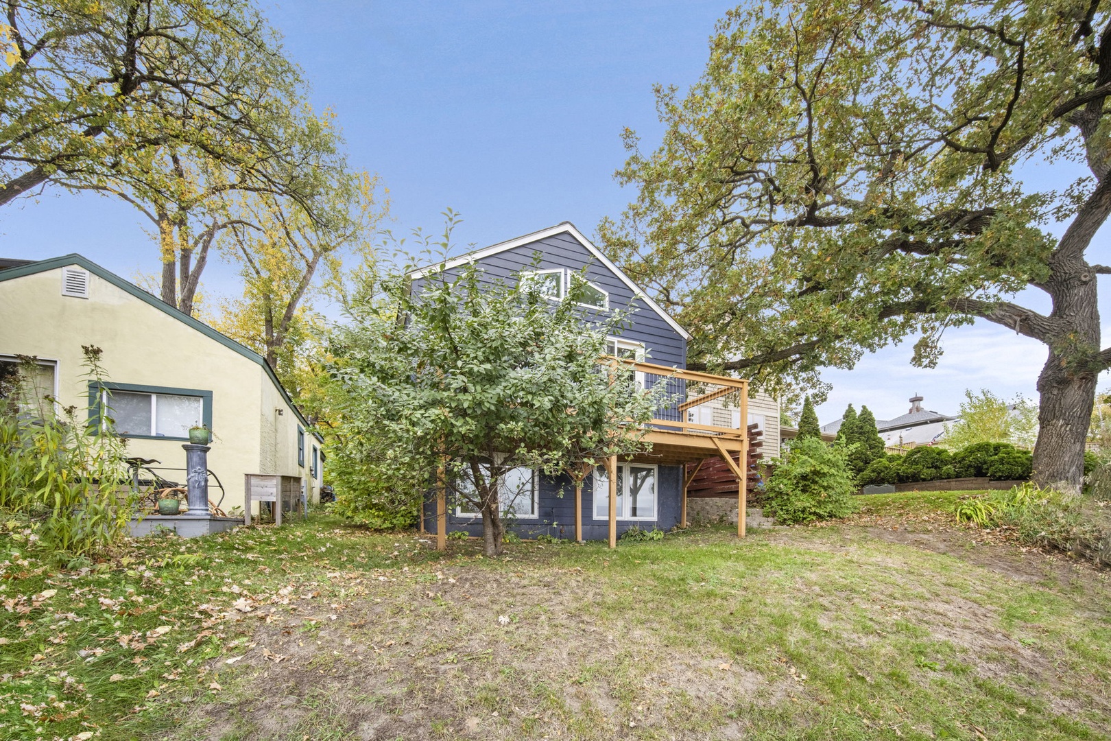 Nestled in a quiet neighborhood with mature trees and open green space, this charming property offers a peaceful arrival experience amid natural surroundings.