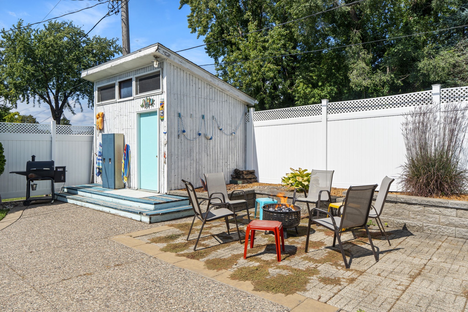 Your private outdoor retreat features a charming shed, cozy seating area, and firepit for memorable evenings under the stars.