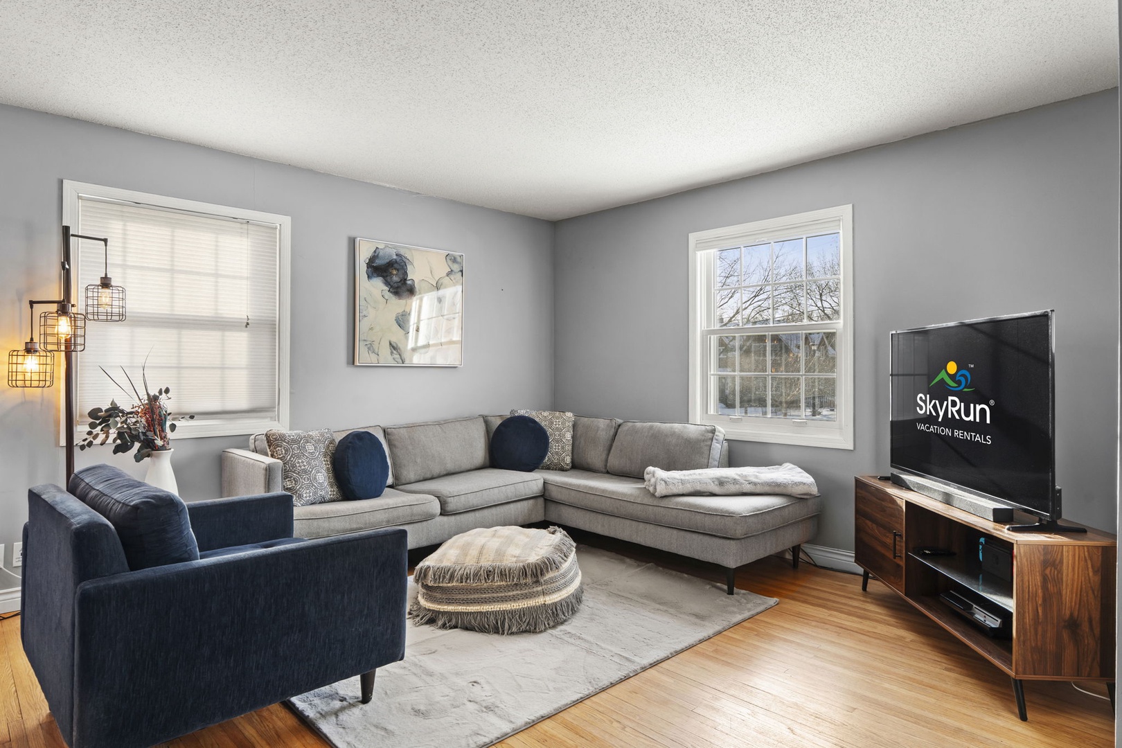 Sink into the plush sectional sofa and unwind in your stylish living room, complete with modern entertainment center for cozy movie nights.