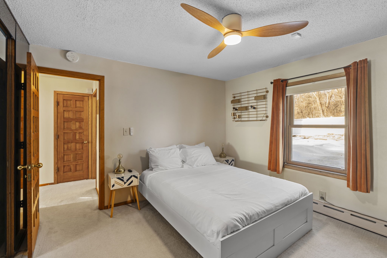 Wake up refreshed in your serene bedroom, where crisp linens and a gentle ceiling fan create the perfect sleeping sanctuary.