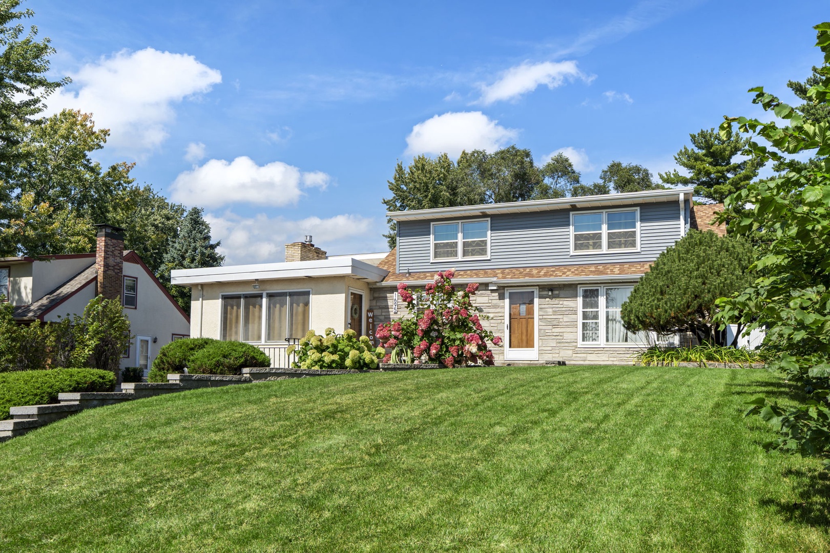 Modern property with spacious lawn and landscaping in a peaceful residential neighborhood.