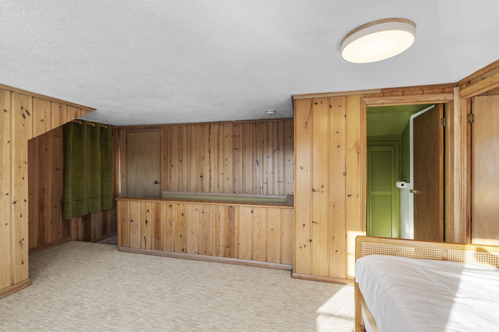 The stairs to the second floor lead to a multipurpose space with a trundle bed that can convert into a king size bed.