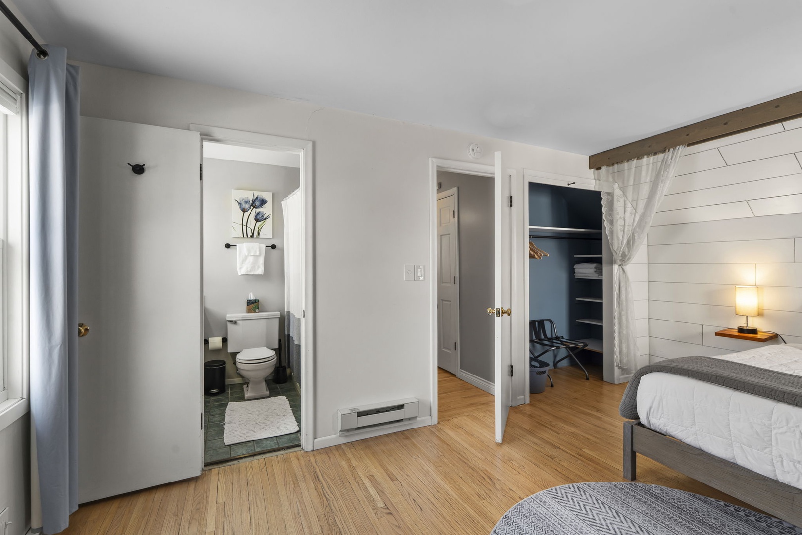 28 — En Suite Bathroom and Blue Accent Closet Visible from Upper Bedroom