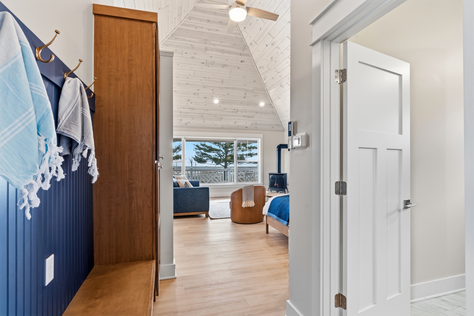 Step into your private coastal retreat where whitewashed vaulted ceilings and warm wood accents create a serene atmosphere, while wide windows frame stunning ocean views waiting just beyond your cozy bedroom.
