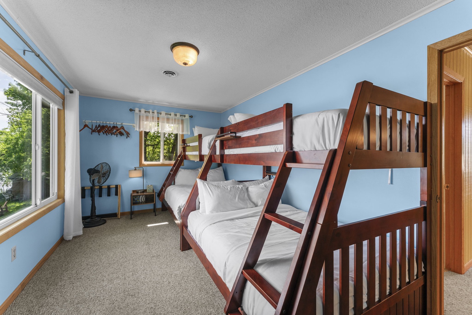 Sink into cozy bunks where natural light fills your space, perfect for family bonding after a day of exploring the surroundings together.