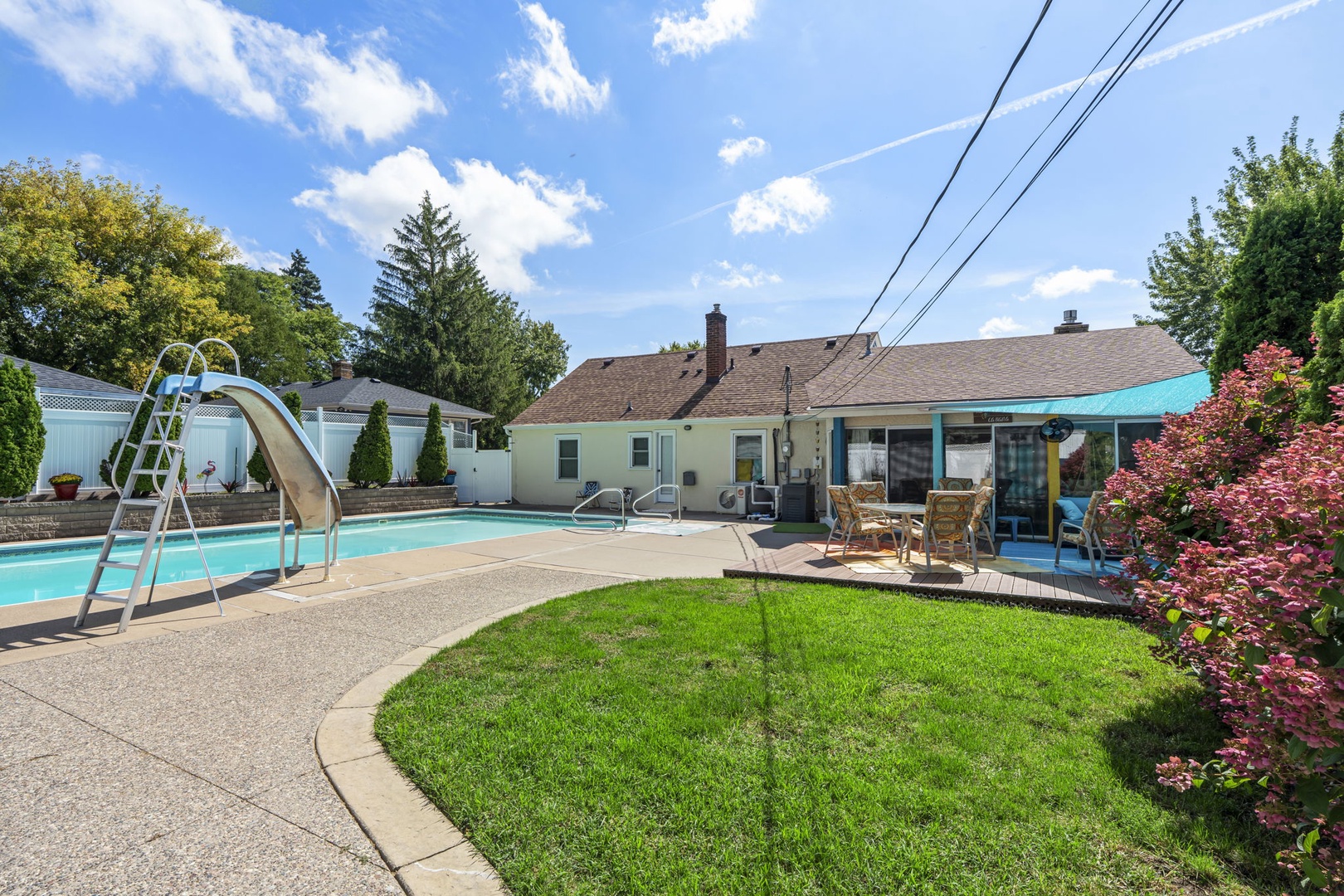 Spacious backyard oasis with covered patio surrounded by mature landscaping and open lawn. Pool is not available for guest use per Minnesota state law.