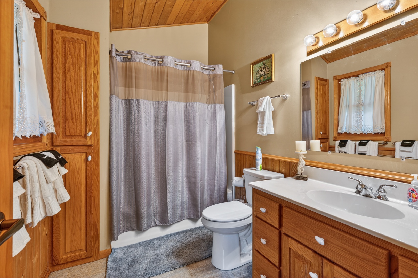 This second floor full bathroom offers warm wood tones and thoughtful touches—fresh towels and toiletries ready for your arrival.