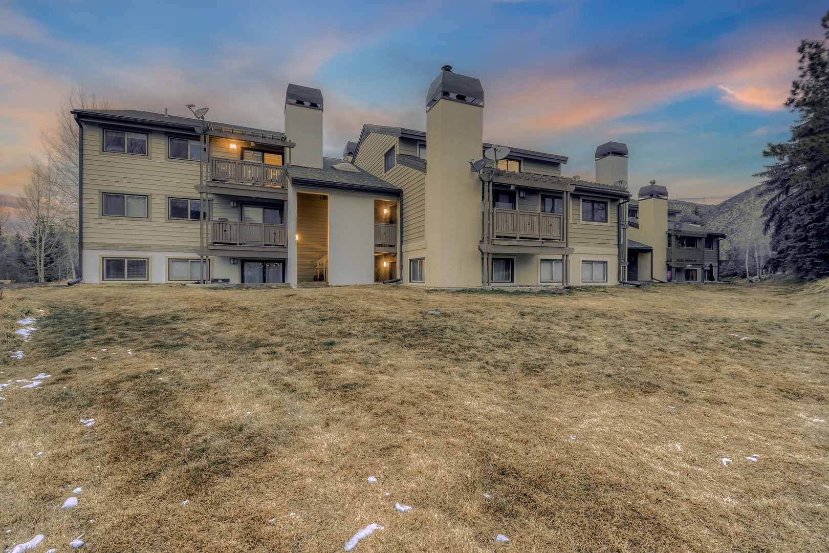 Multi-level mountain condominium complex featuring modern architecture with balconies