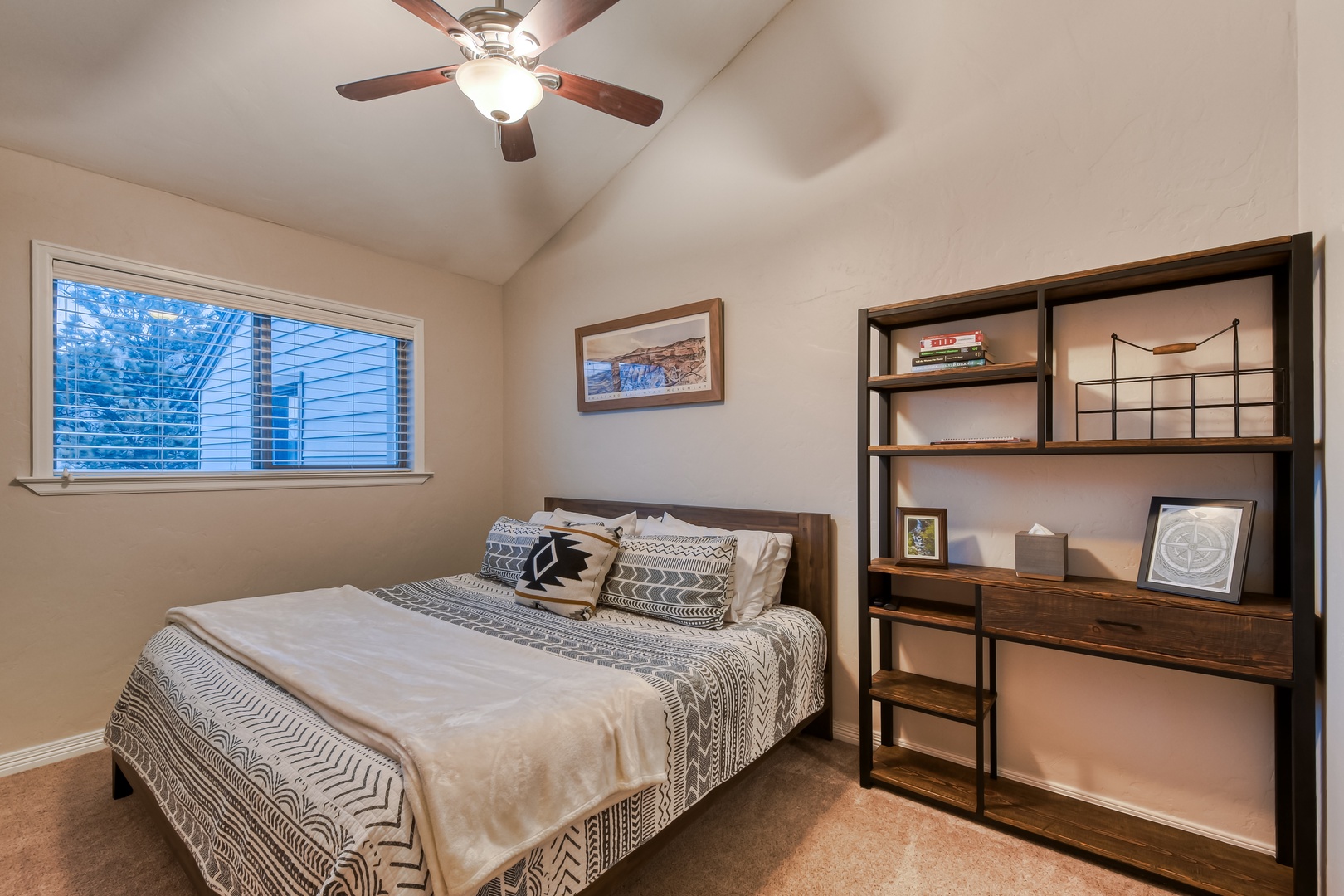 Relax in your peaceful bedroom with natural light streaming through blinds.