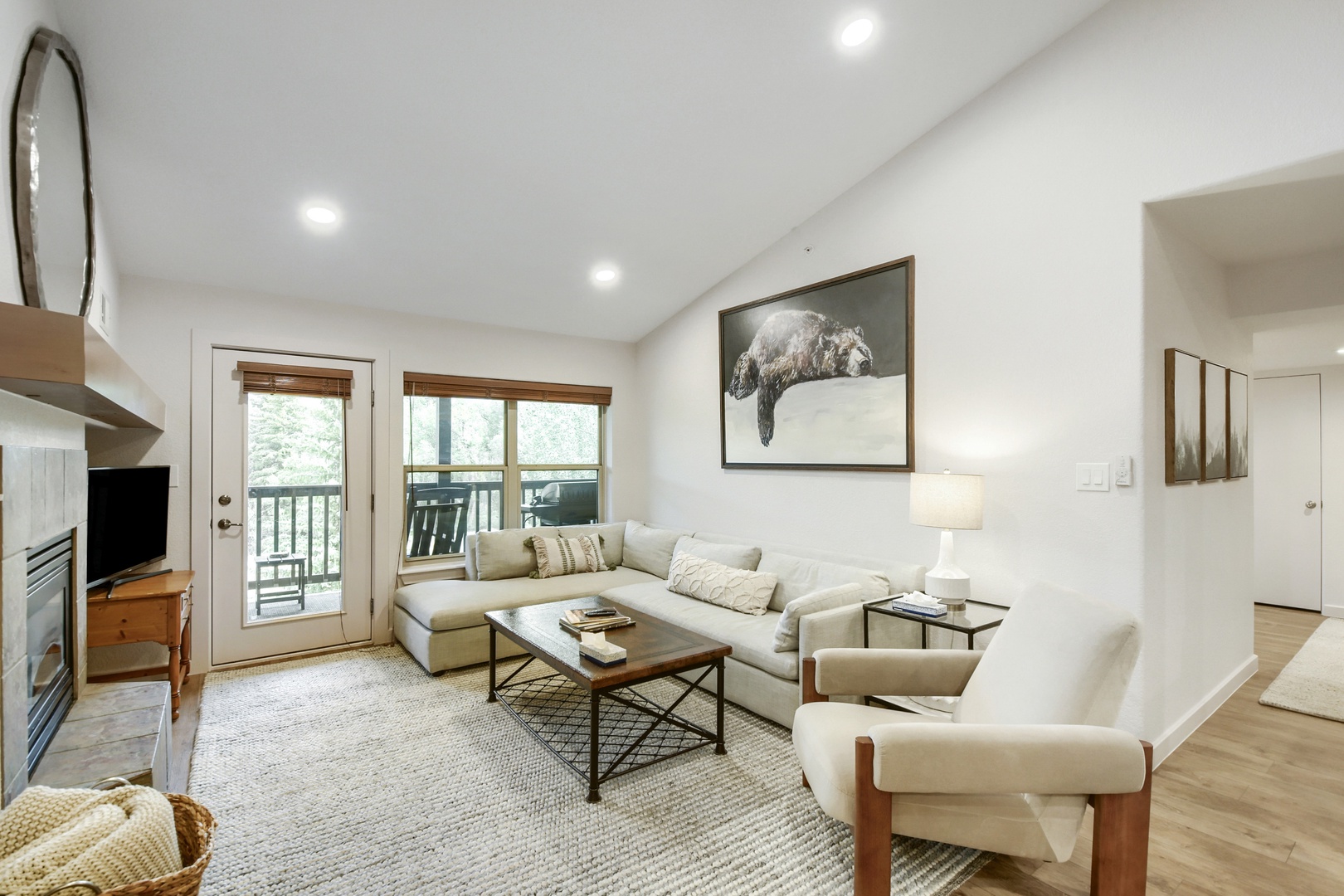 Sink into the plush sectional and unwind in your bright, airy living room. Natural light streams through the patio doors, inviting you to step outside and enjoy the fresh mountain air.
