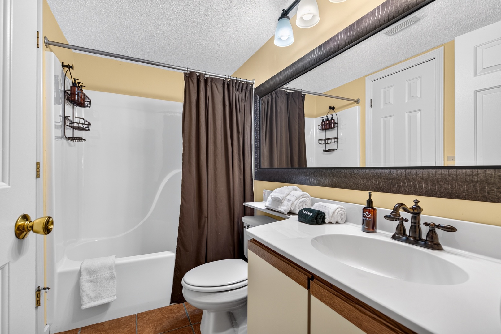 Your private bathroom features a clean tub-shower combo, fresh towels, and thoughtful storage to help you settle in and refresh after a day of exploring.