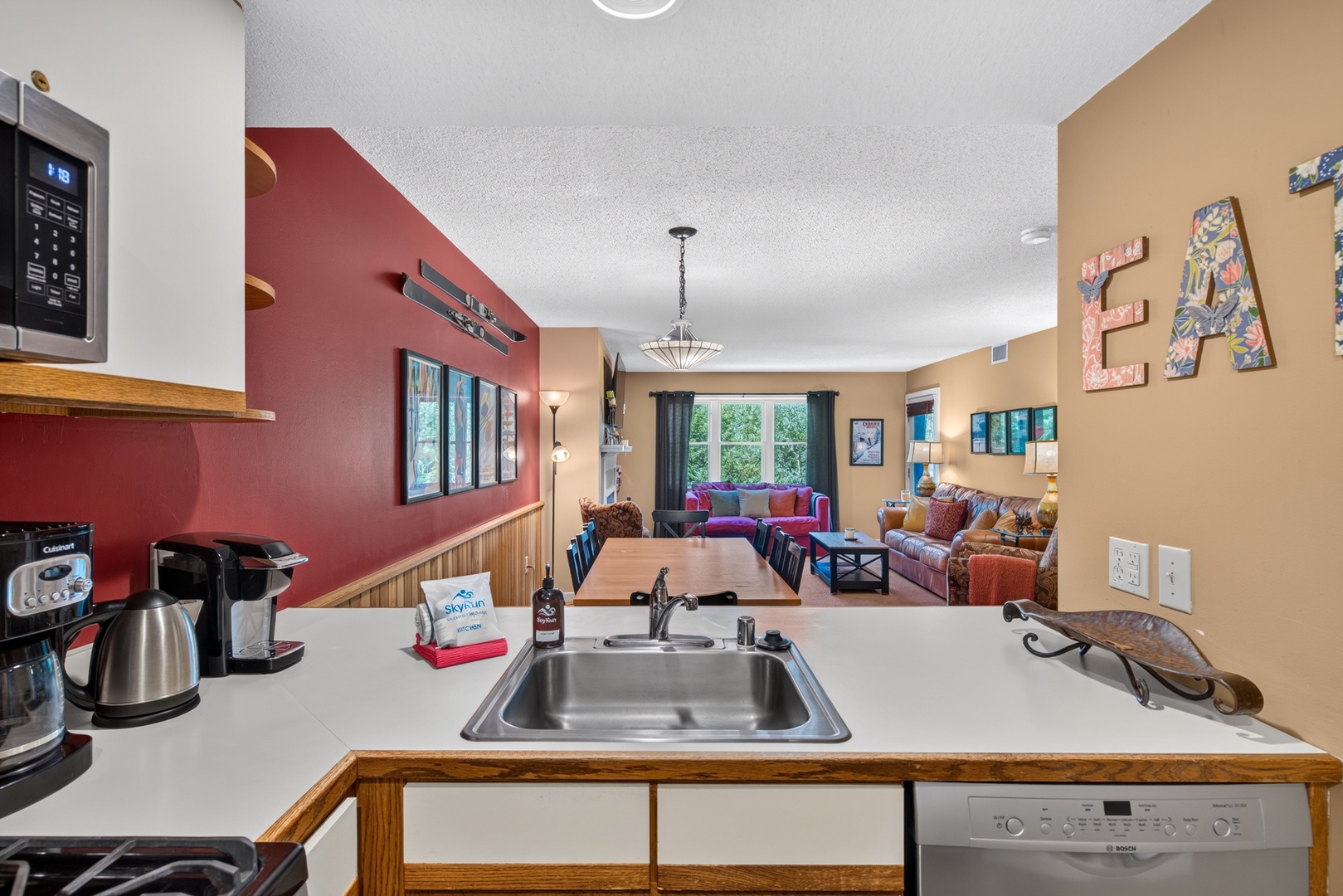 Your kitchen flows into a vibrant living space where colorful accents and plenty of natural light create a welcoming retreat after a day of adventure.
