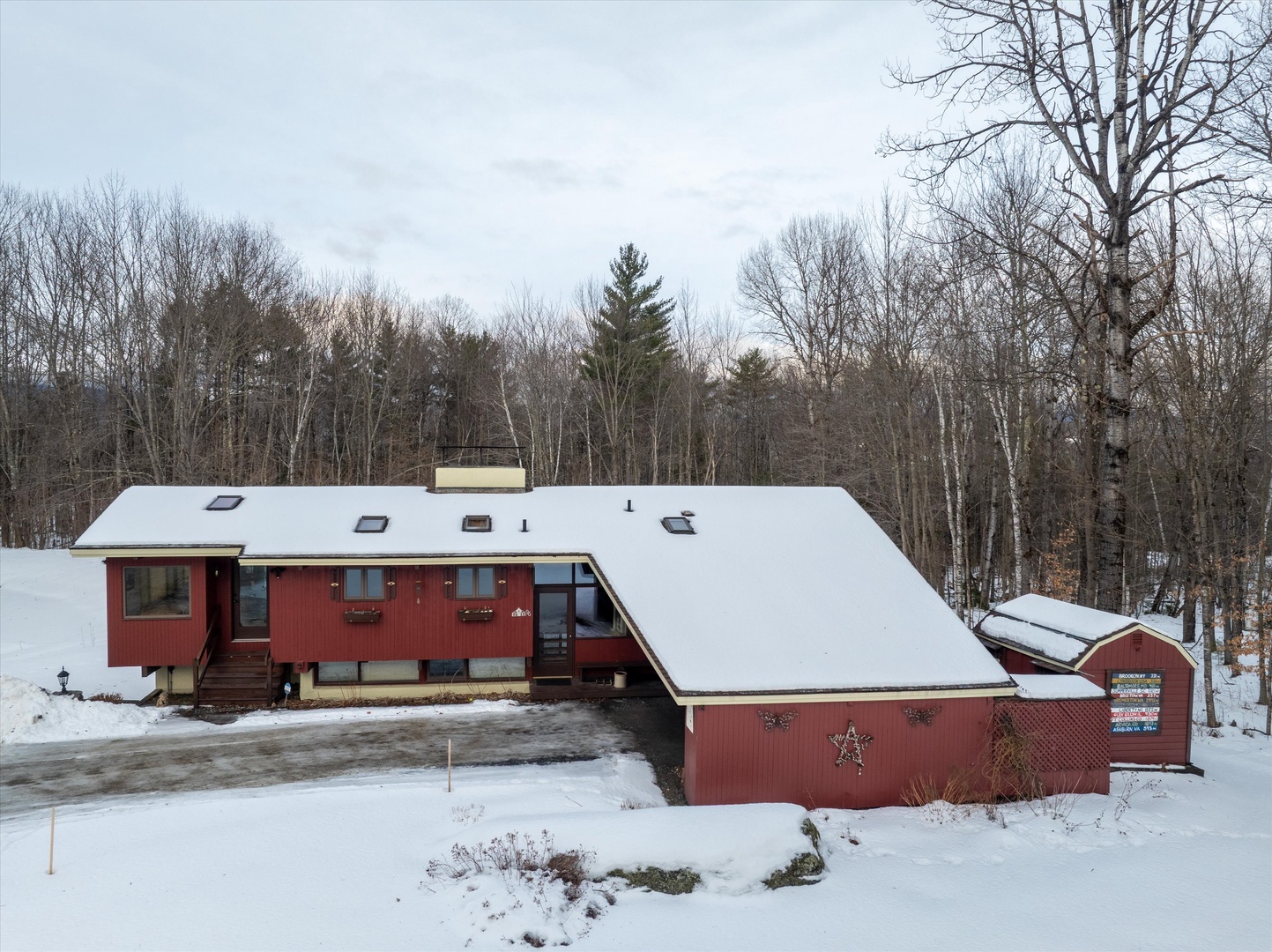 Charming mountain home set among snow-covered trees, creating a peaceful winter escape in a serene forest setting.