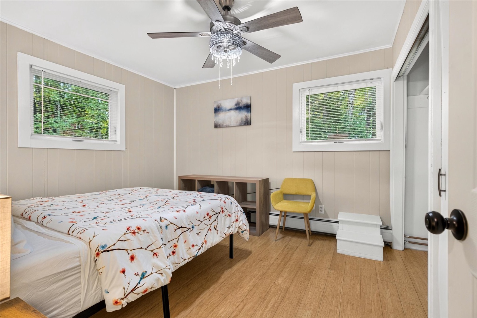 Step into your tranquil retreat with soft neutral tones and natural light streaming through your windows. The elegant ceiling fan keeps you comfortable while you rest on your cozy bed, perfect for unwinding after exploring the area.