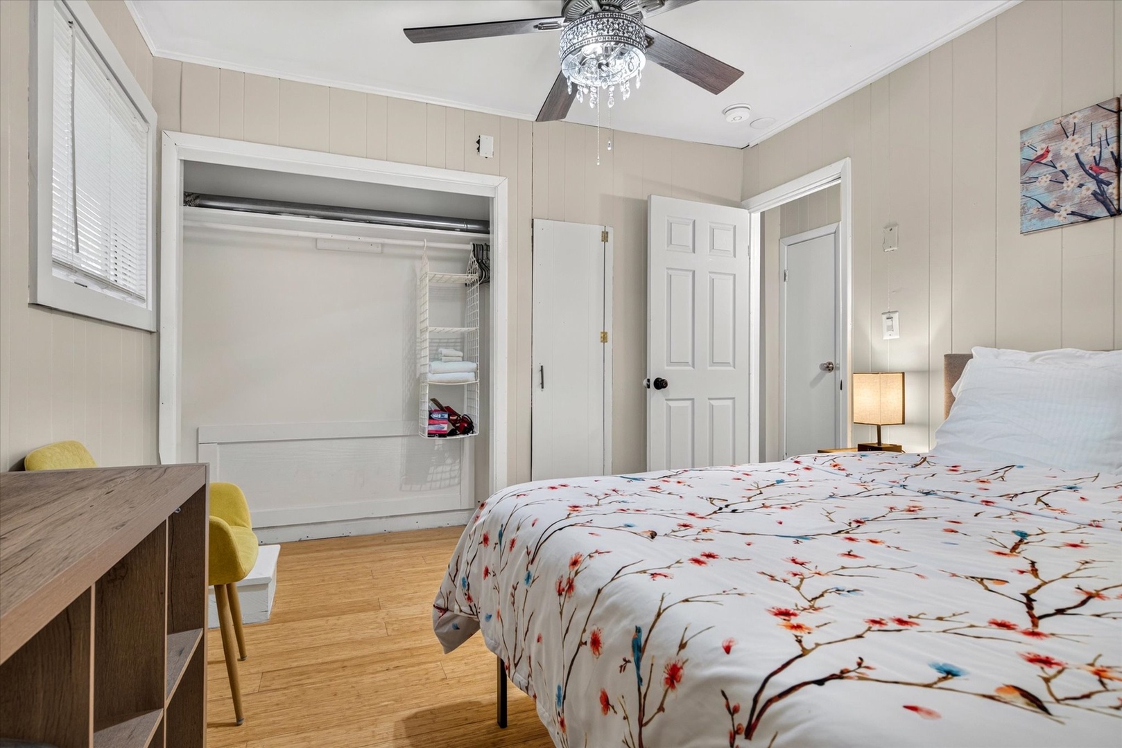 Slip into fresh linens beneath a charming chandelier fan and unwind in your bright, cozy bedroom with tasteful décor and plenty of storage for your belongings.