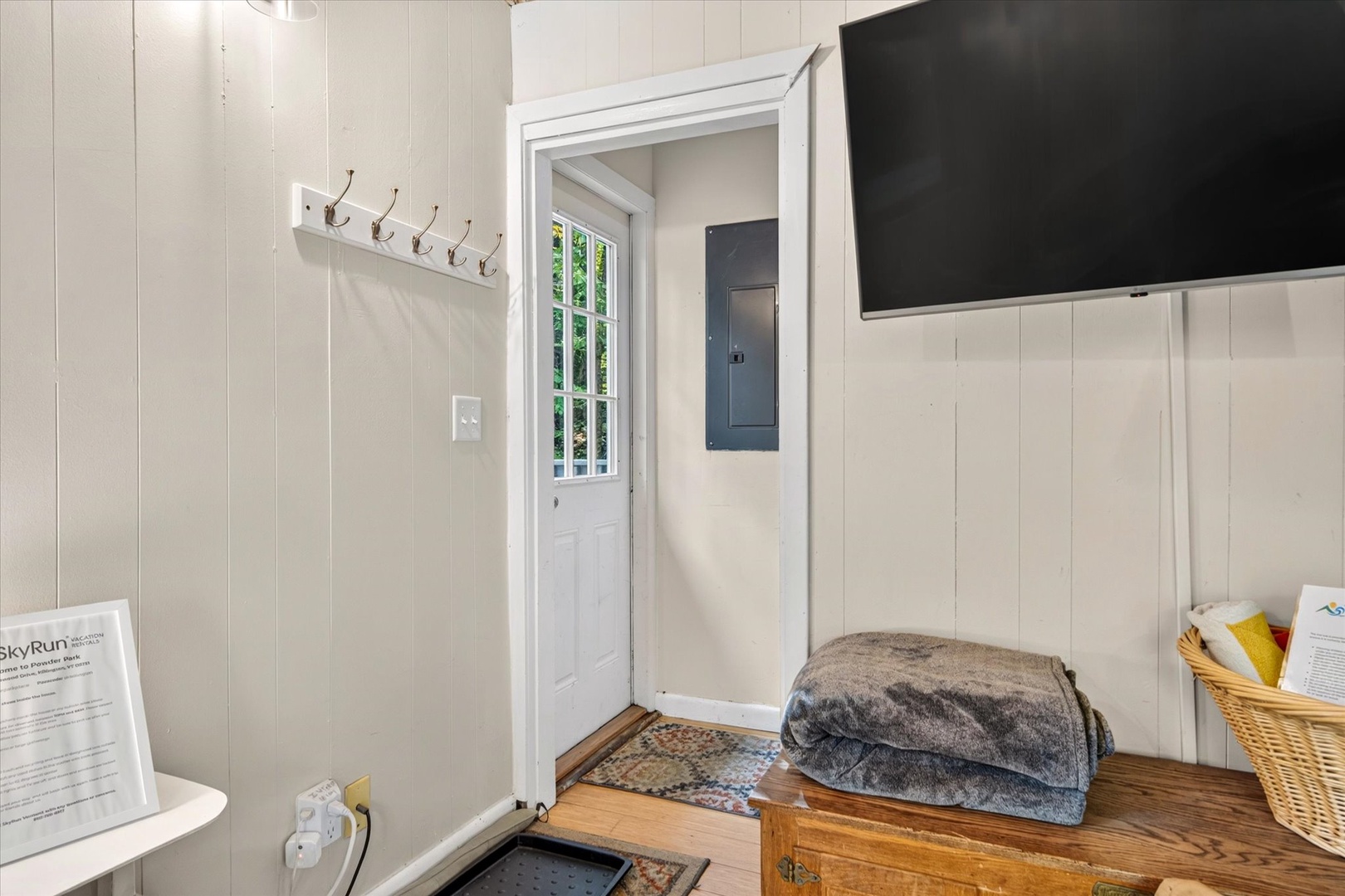 Step inside your cozy retreat, where rustic wood benches offer a place to settle in and fresh towels await your arrival.