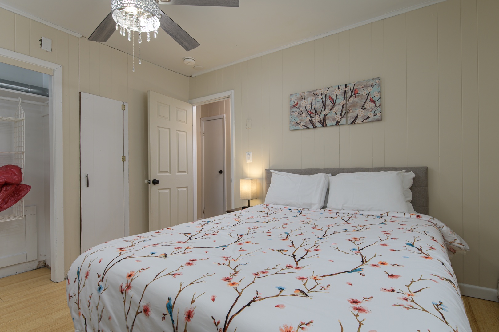 A cozy queen bed awaits in this cheerful bedroom, perfect for reading, relaxing, or simply taking a break.