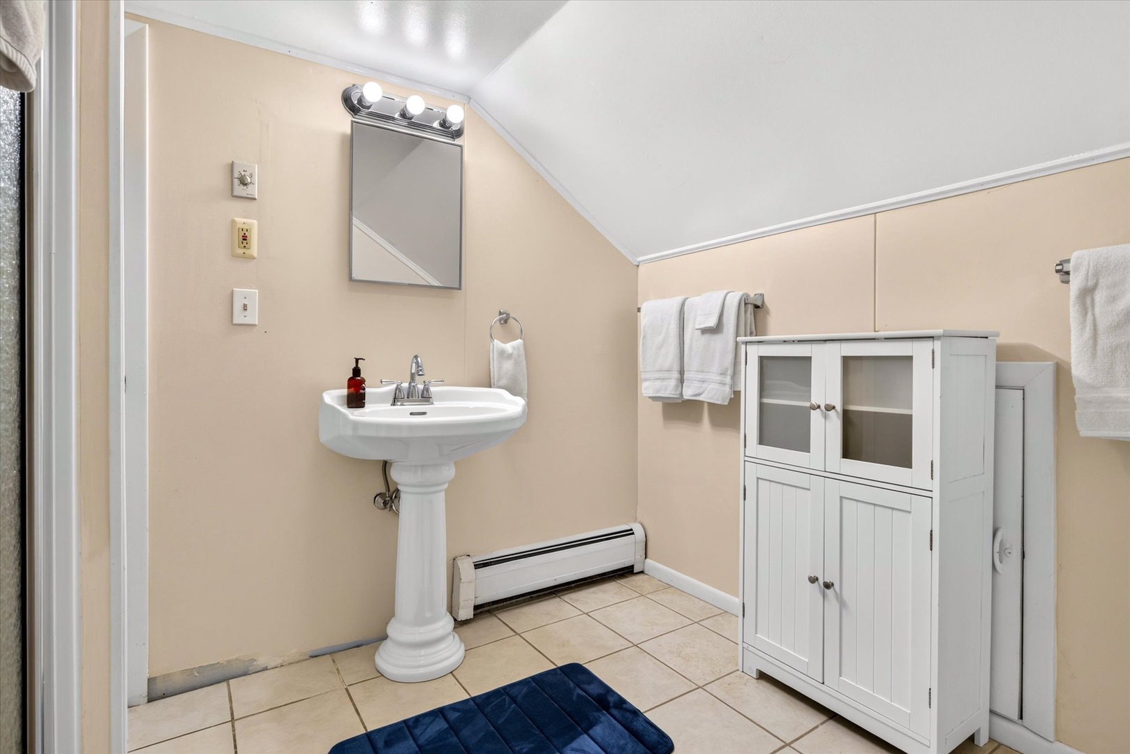 Freshen up in your private bathroom with a classic pedestal sink and plenty of storage for your essentials.
