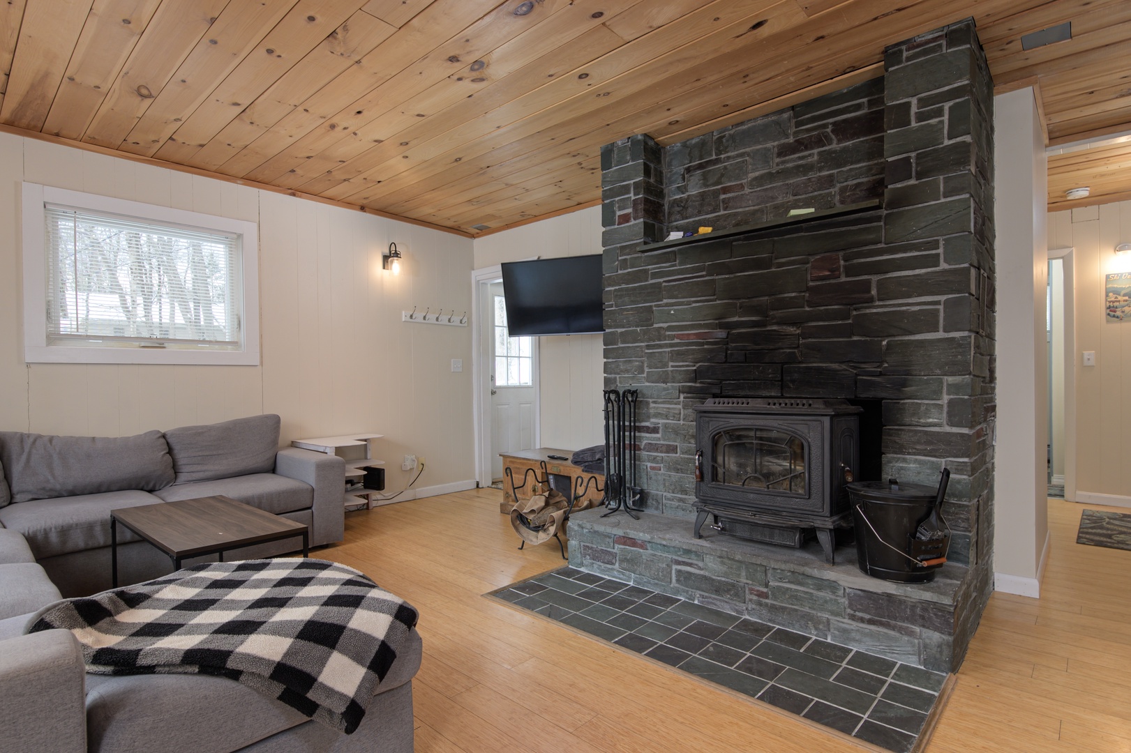 Upper-level living room with a spacious layout, fireplace, and TV—an inviting spot to gather, relax, and unwind together.