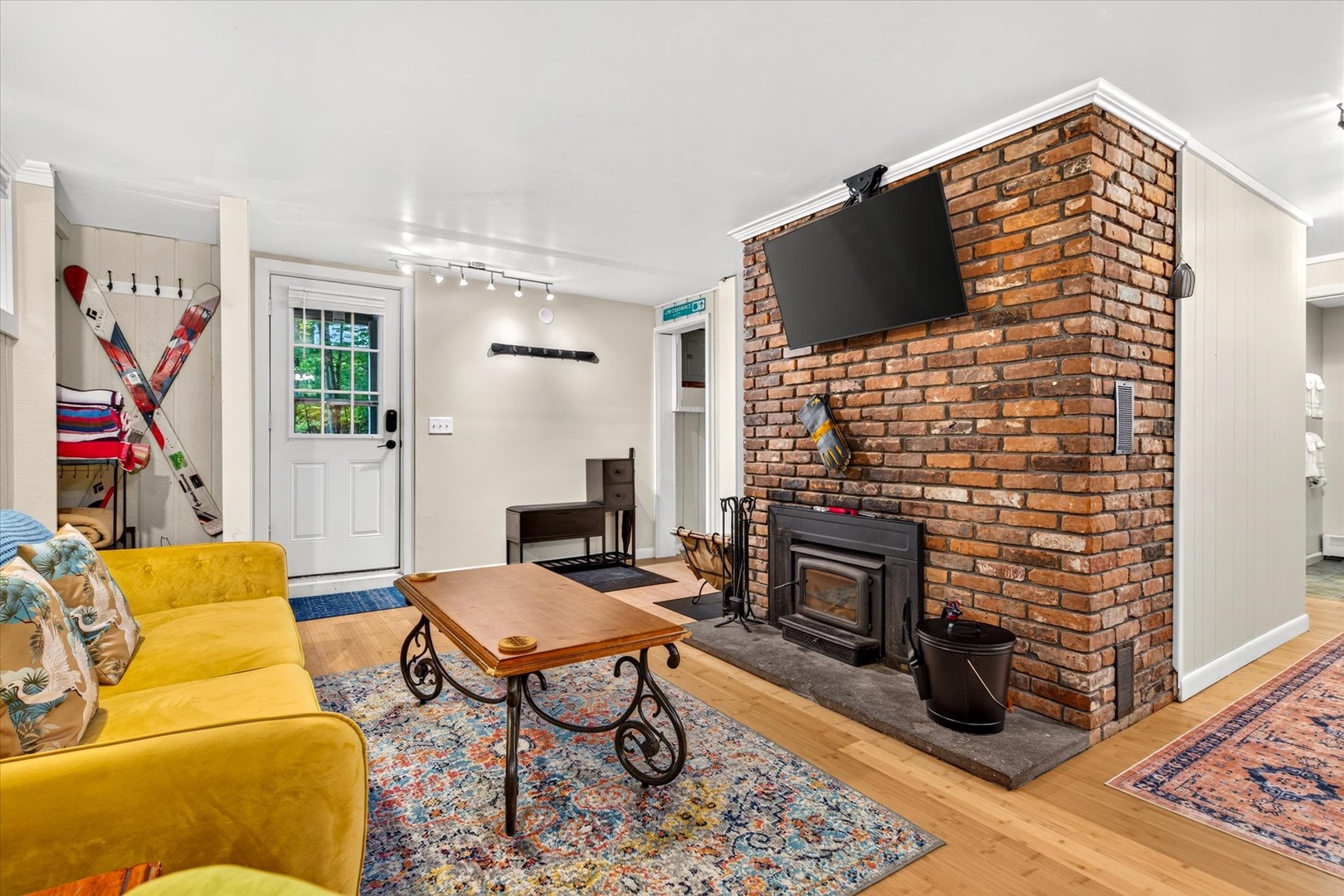 Cozy up in your welcoming living room with a charming brick fireplace and comfortable seating—perfect for unwinding after mountain adventures or catching your favorite shows.