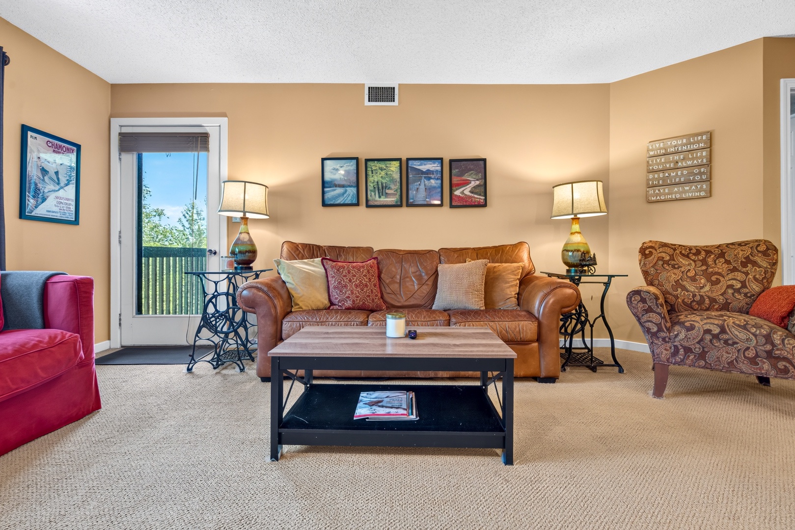 Settle into your welcoming living space, where comfortable seating and warm lighting create the perfect spot to unwind after your adventures. The open door invites fresh air and natural light into your home away from home.