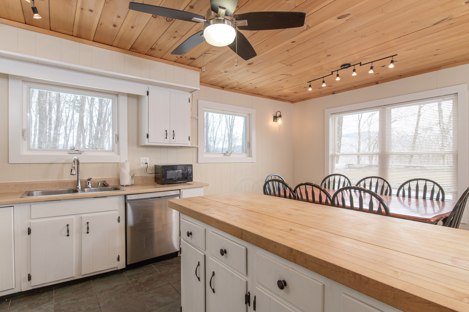 Your spacious kitchen features warm wood counters and seating for ten, perfect for family meals with forest views.