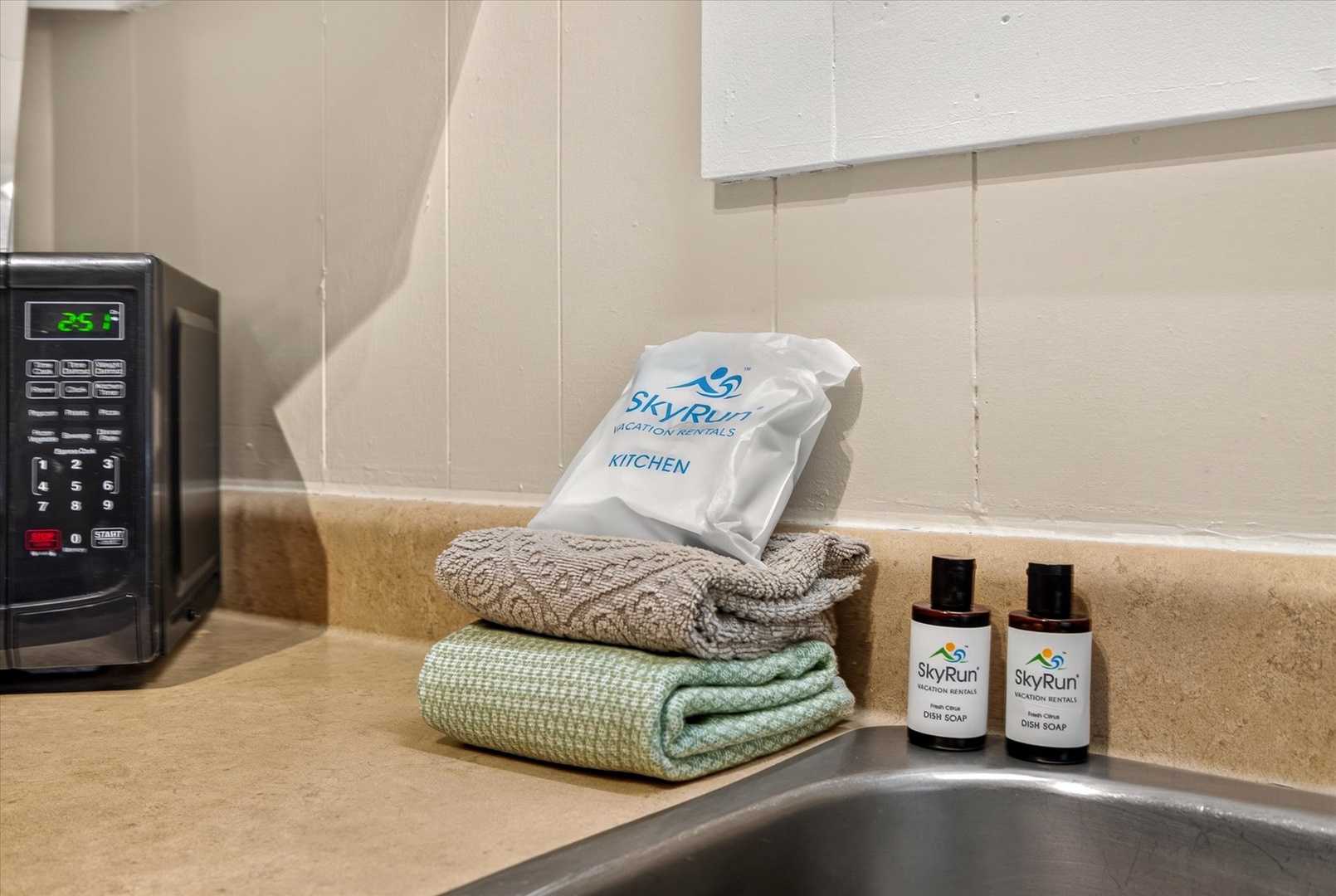 Your kitchen comes stocked with essentials like fresh towels, dish soap, and a microwave—ready for easy meal prep and cleanup.