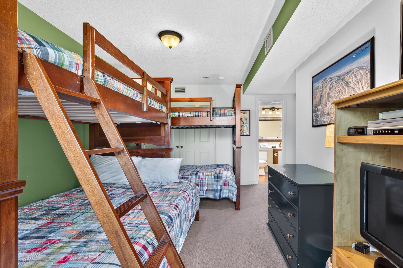 Your cozy bunk room sleeps the whole crew with sturdy wood bunks and plaid bedding that feels like a mountain retreat. The convenient en-suite and kitchenette make it easy to settle in and unwind.