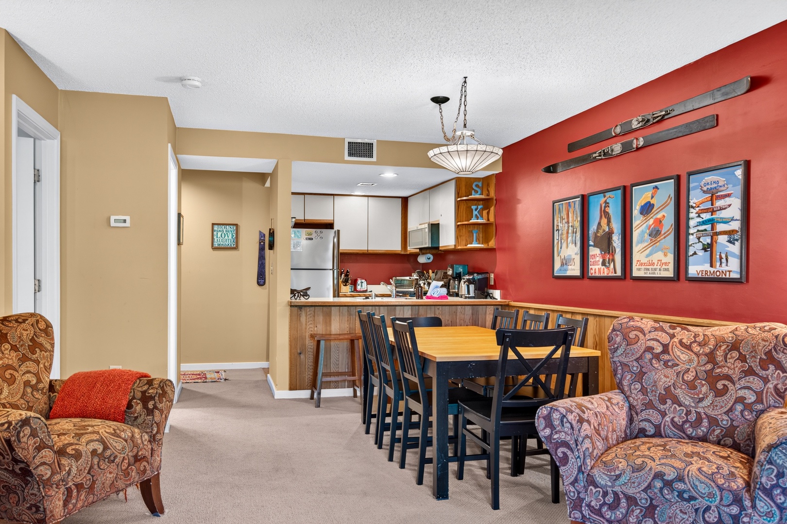 Gather around the dining table for meals and games in this welcoming open space, complete with a well-equipped kitchen and cozy seating for relaxing after your mountain adventures.
