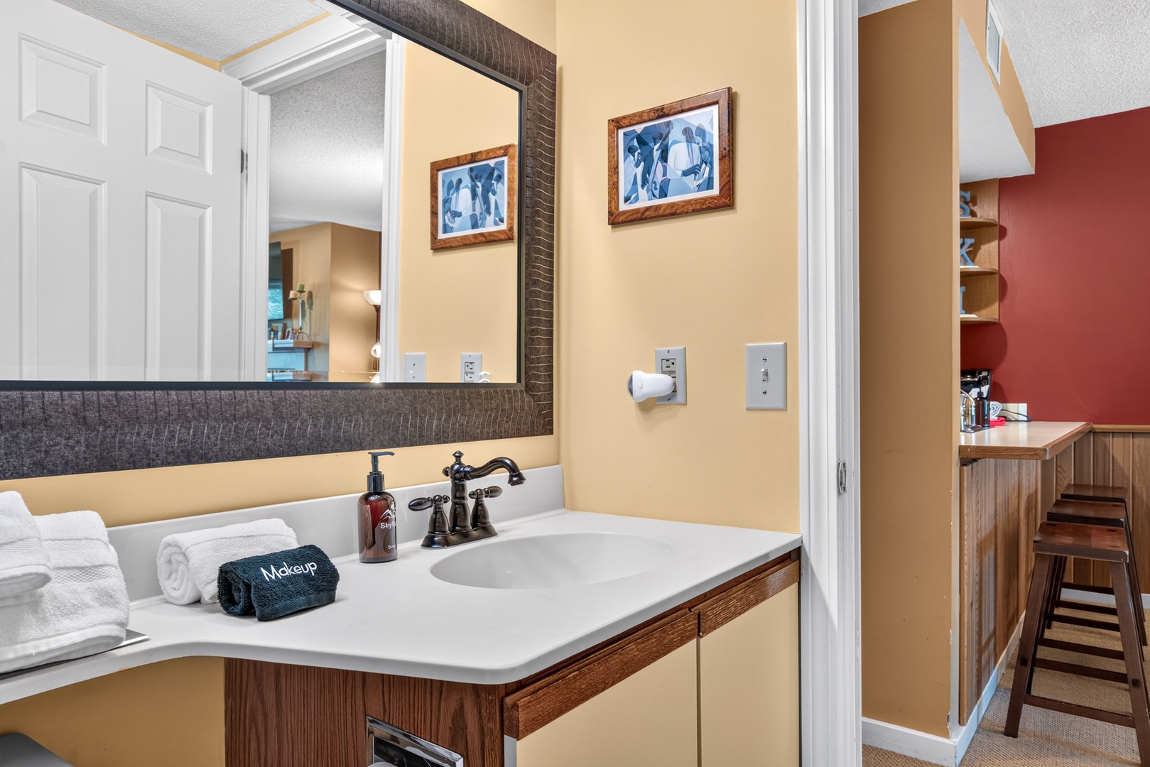 Step into your welcoming bathroom where fluffy white towels and a thoughtfully appointed vanity await—your perfect retreat for getting ready each morning or unwinding after a long day.