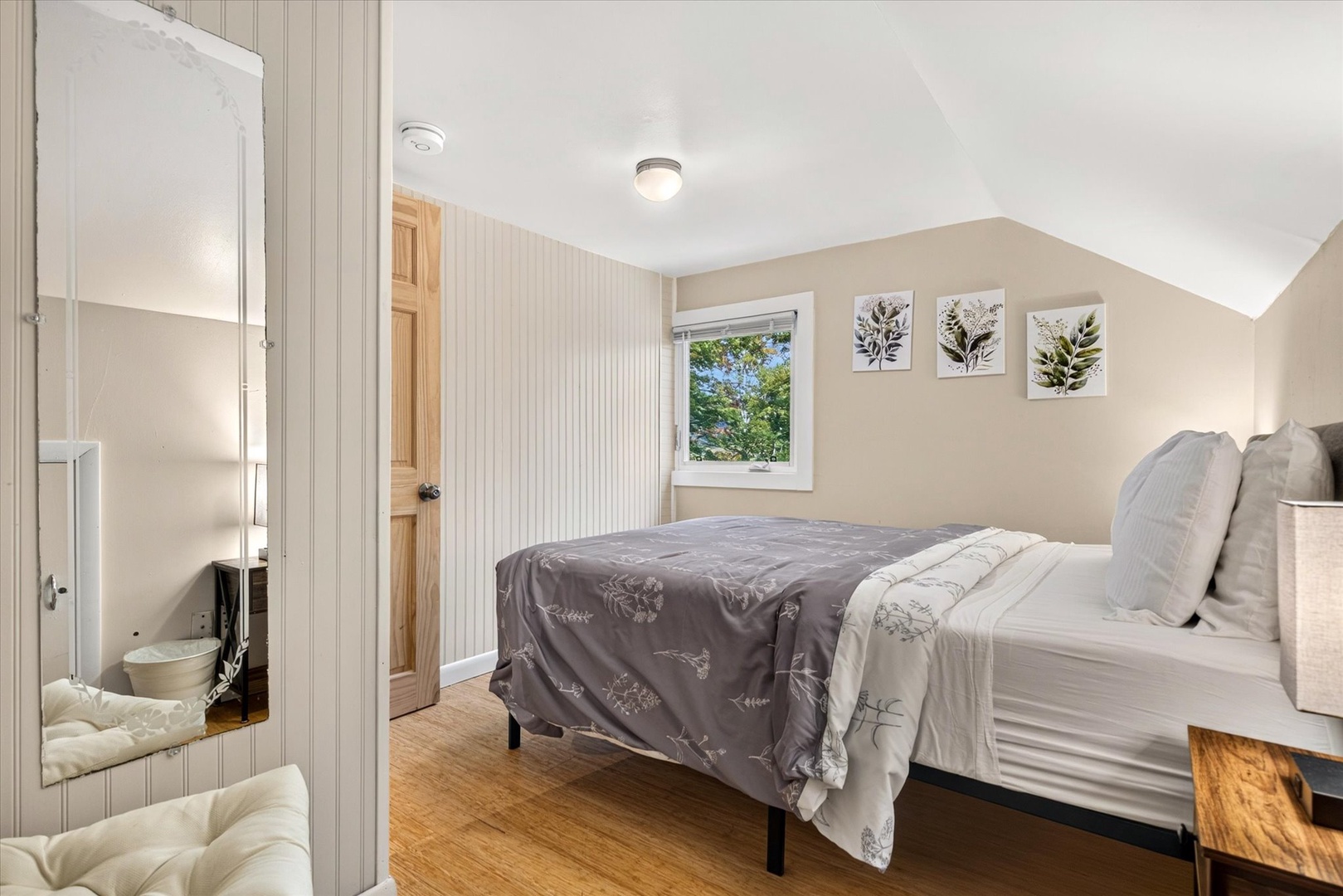 Relax in your peaceful bedroom featuring soft neutral tones, a comfortable bed, and natural light streaming through the window. The cozy space offers a serene retreat after exploring.