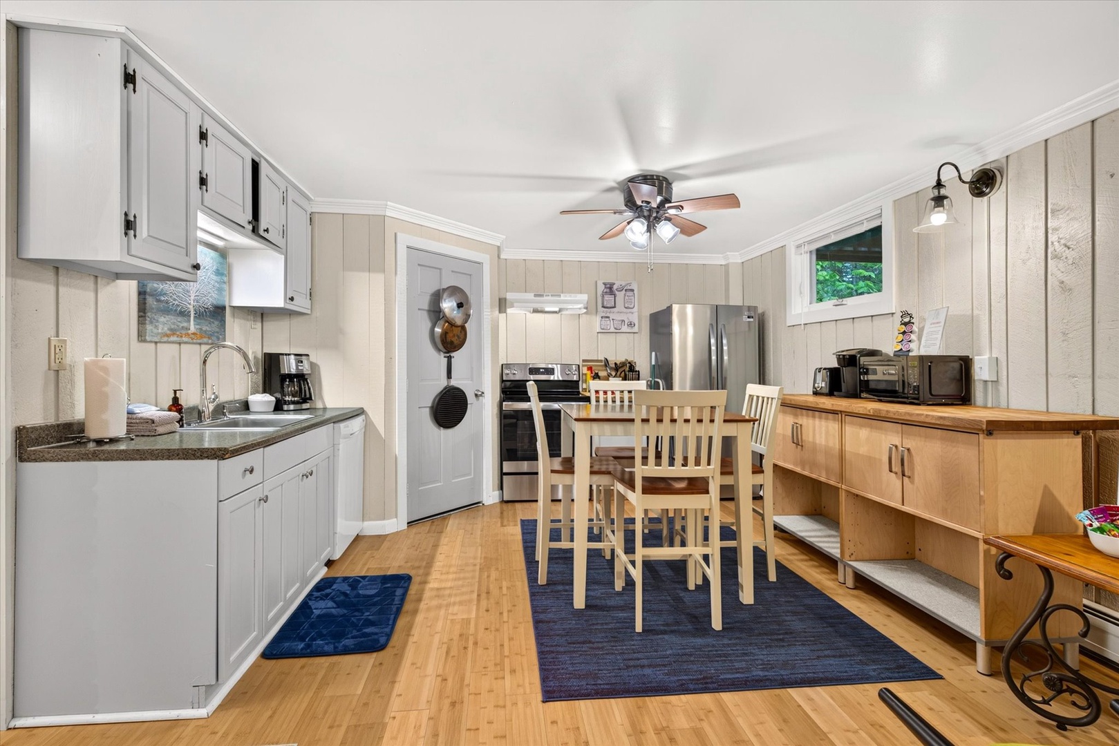 Step into your fully equipped kitchen and dining area, where you'll find everything you need to prepare and enjoy home-cooked meals during your stay, complete with modern appliances and welcoming cottage charm.