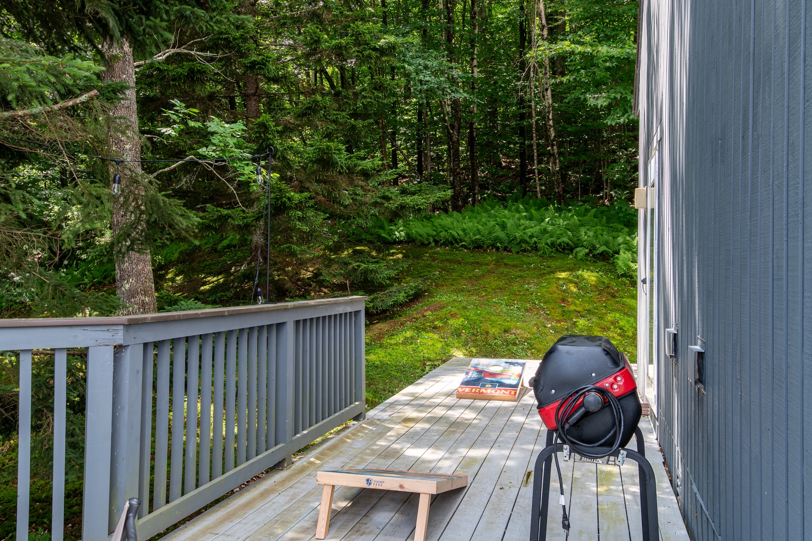 This peaceful deck opens directly onto lush woods, offering a tranquil space where you can unwind with morning coffee or enjoy alfresco dining surrounded by nature's beauty.