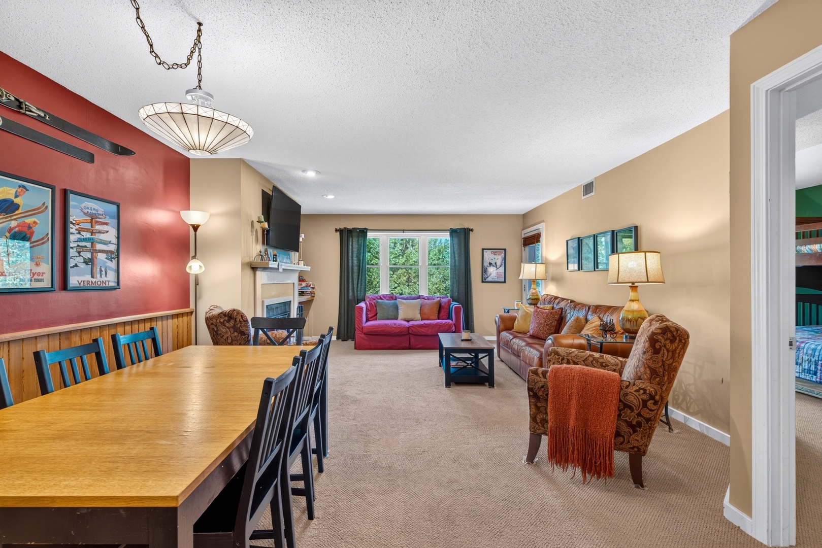 Gather in this inviting open-plan space where warm lighting and colorful seating create the perfect spot for your group to relax, dine, and unwind together after a day of mountain adventures.