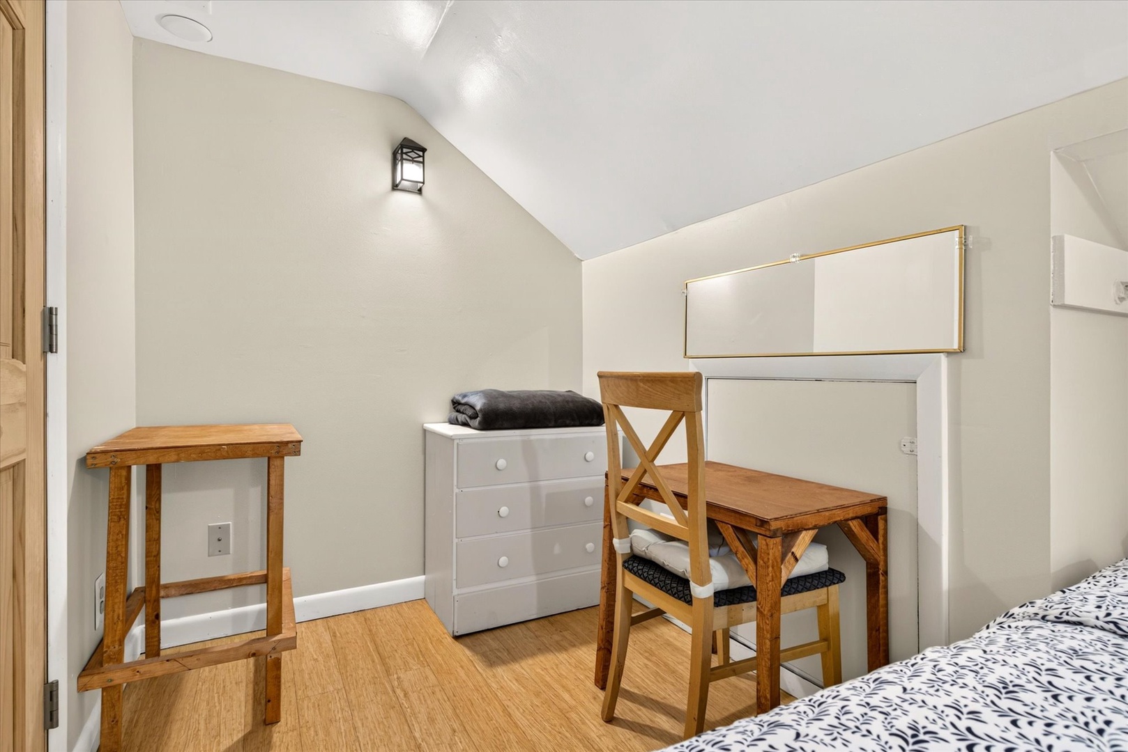 Your cozy bedroom features warm wood tones, vaulted ceilings, and everything you need to feel at home, from the vanity desk to ample storage for your belongings.