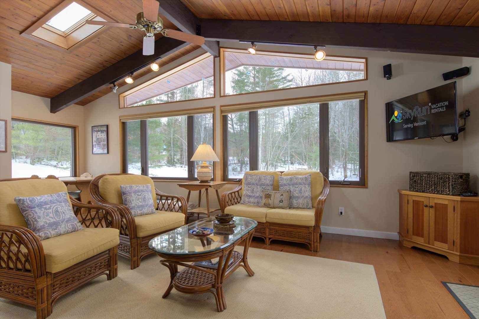 Take in the serene winter forest views from this bright living room, with cozy wicker seating for everyone to enjoy.