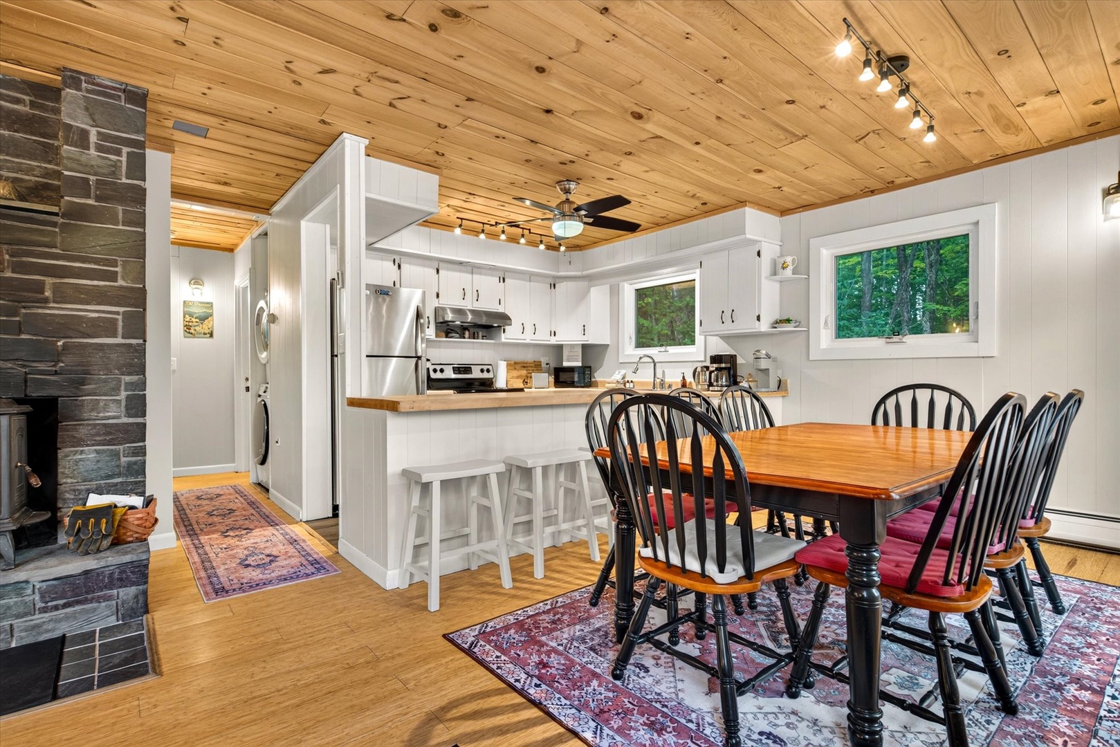 Gather around the warm farmhouse table or perch at the breakfast bar in your fully equipped kitchen, surrounded by rustic wood ceilings and charming touches that make every meal feel like home.