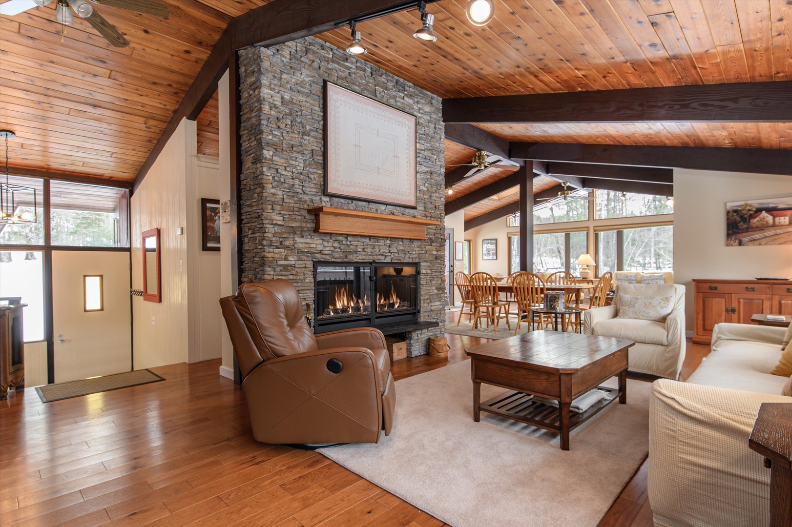 Unwind in your spacious living room where exposed beams and a stone fireplace create rustic elegance.