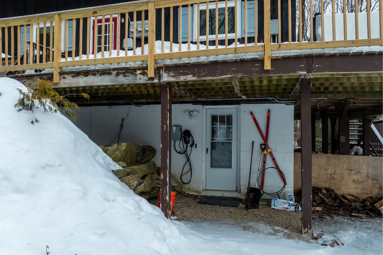 Easy ground-level entry to your mountain retreat, complete with ski storage, a gear prep area, and a shared EV charger under the upper deck.