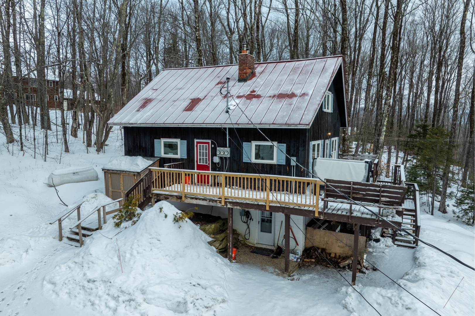Secluded lower-level unit in the snowy woods, ideal for a peaceful Killington getaway.