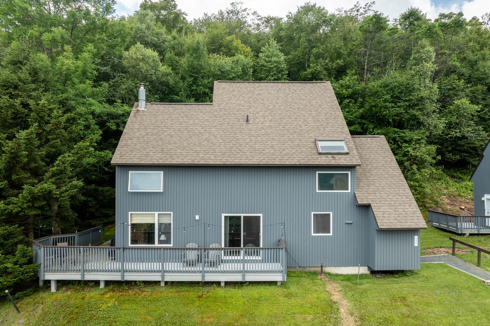 Nestled privately among lush forest, this charming mountain retreat features a spacious wraparound deck and peaceful woodland setting as part of the surrounding area.