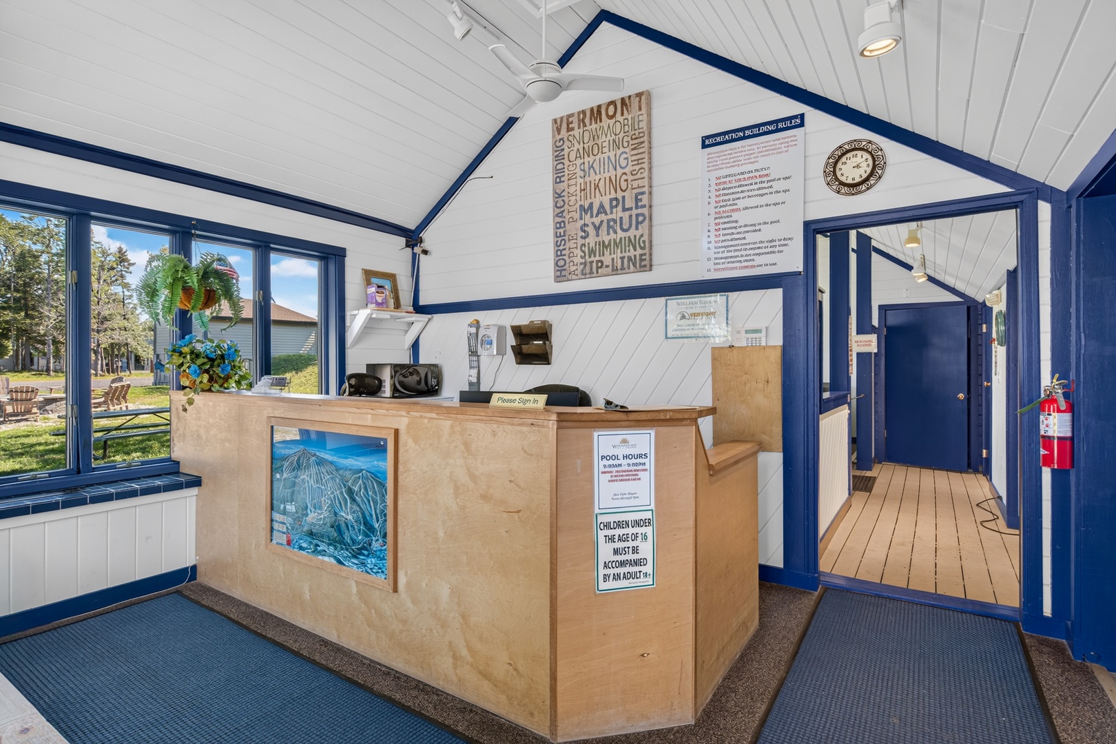 The welcoming reception area features vaulted ceilings and bright natural light, with Vermont-themed decor setting the tone for your mountain getaway.