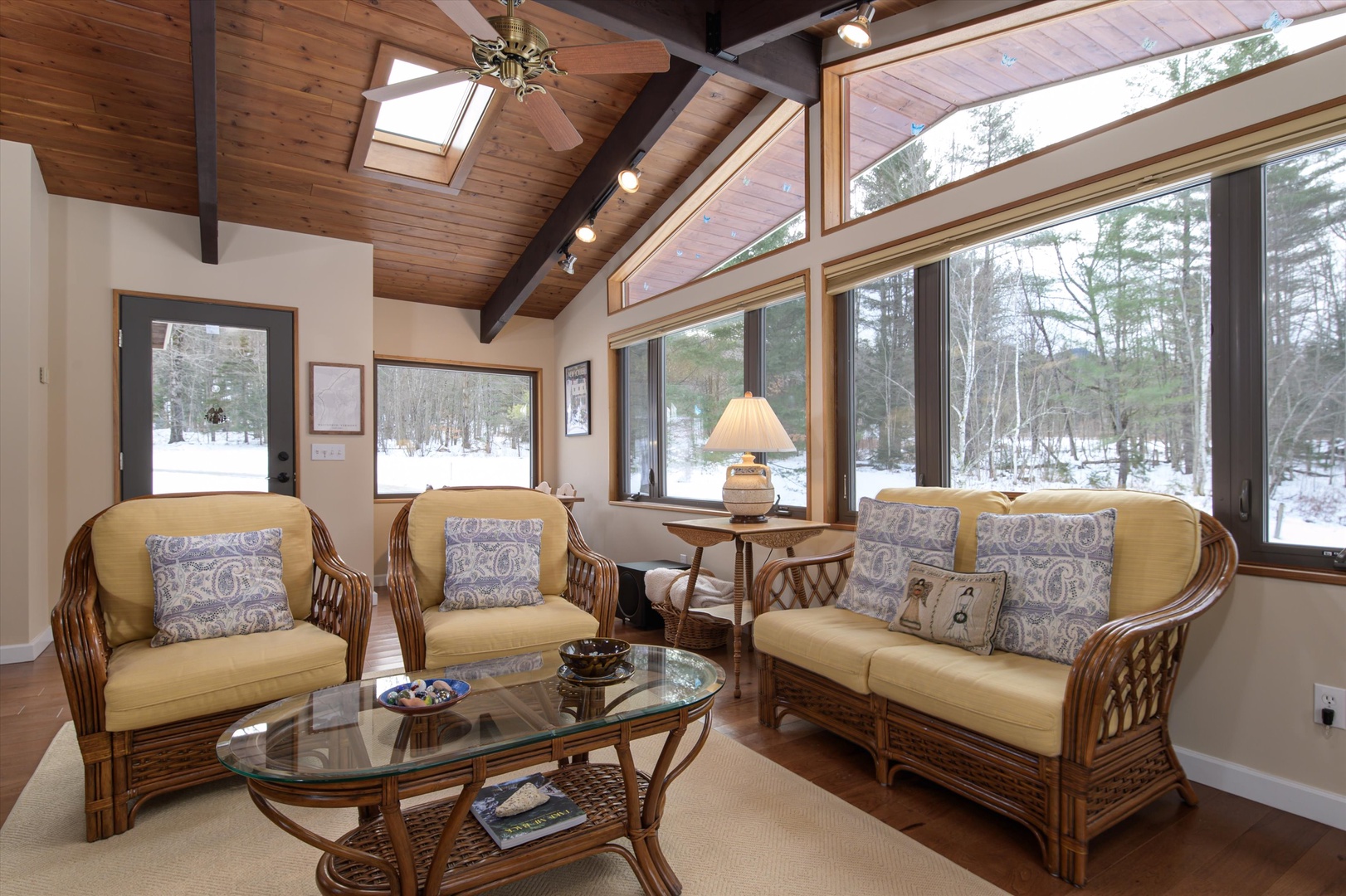 Enjoy your bright sunroom with vaulted wood ceilings and panoramic windows overlooking winter's peaceful landscape.