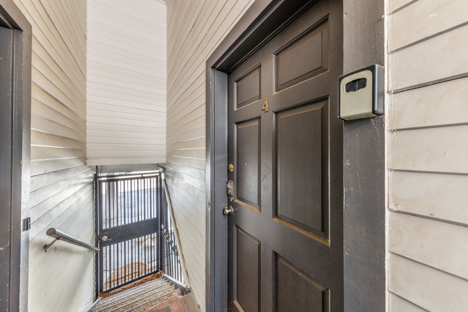 The private entrance welcomes you with secure keypad access, leading to a cozy stairwell that connects to your home away from home.