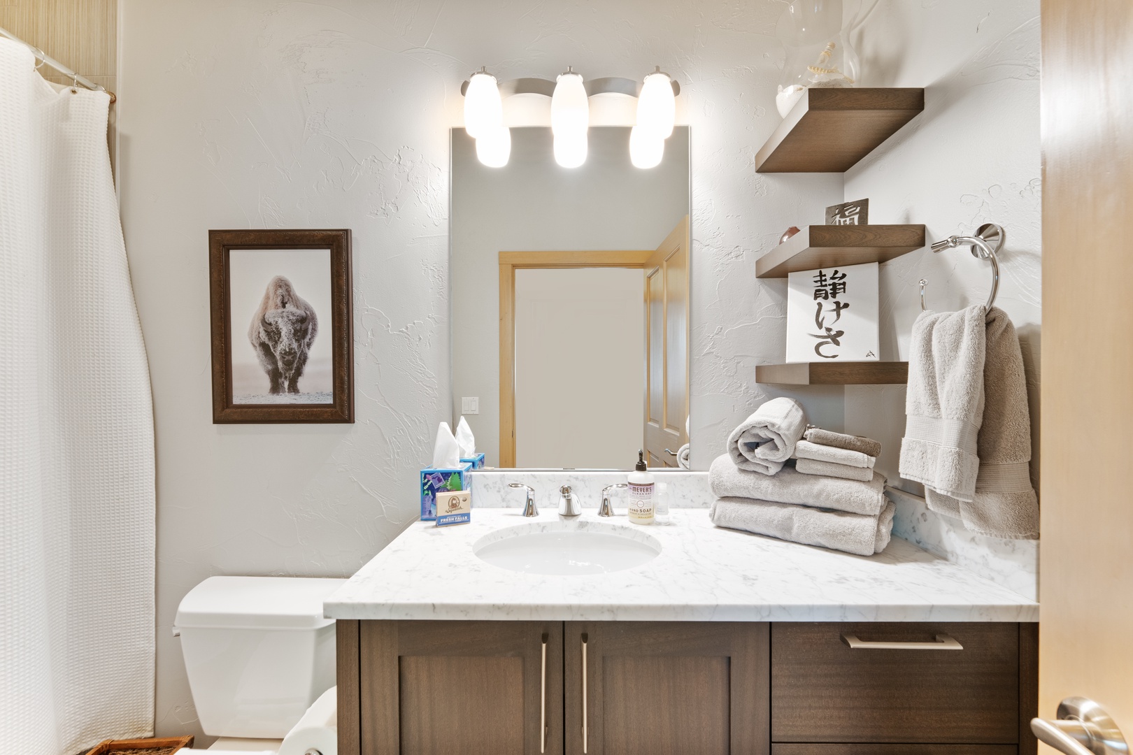 Your private bathroom features marble countertops, soft towels, and thoughtful touches that make freshening up a pleasure during your stay.