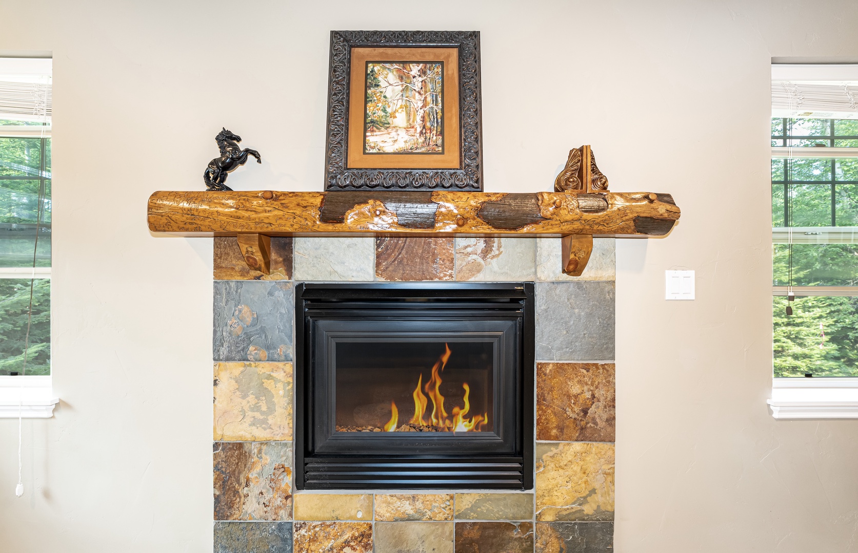 Gather by the stone fireplace with its natural wood mantel, where the warmth and glow create the perfect setting for your mountain evenings.
