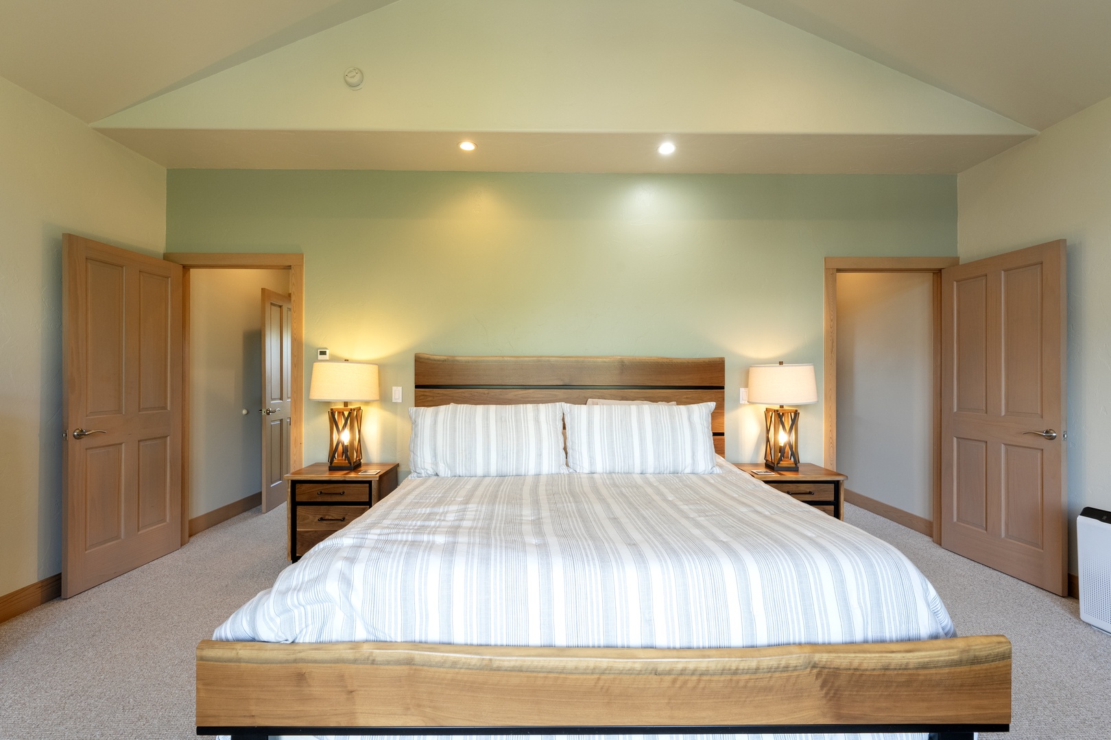 Slip into crisp, freshly made linens and drift off under the gentle glow of bedside lamps—your tranquil retreat with high ceilings and soothing coastal tones awaits.