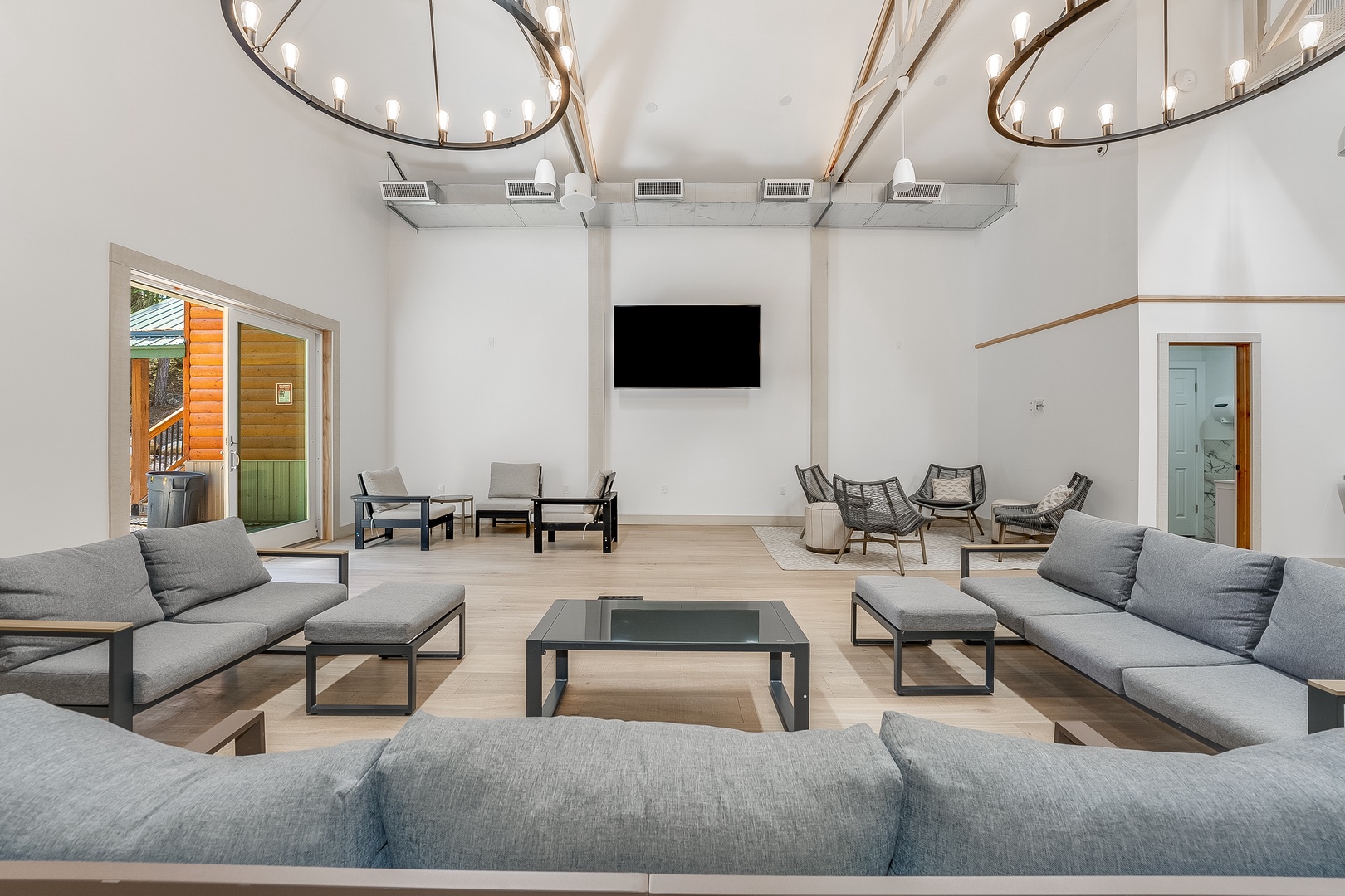 Unwind in your spacious lounge with soaring ceilings and elegant chandeliers. Modern furnishings and a wall-mounted TV create the perfect retreat for relaxing evenings with loved ones.