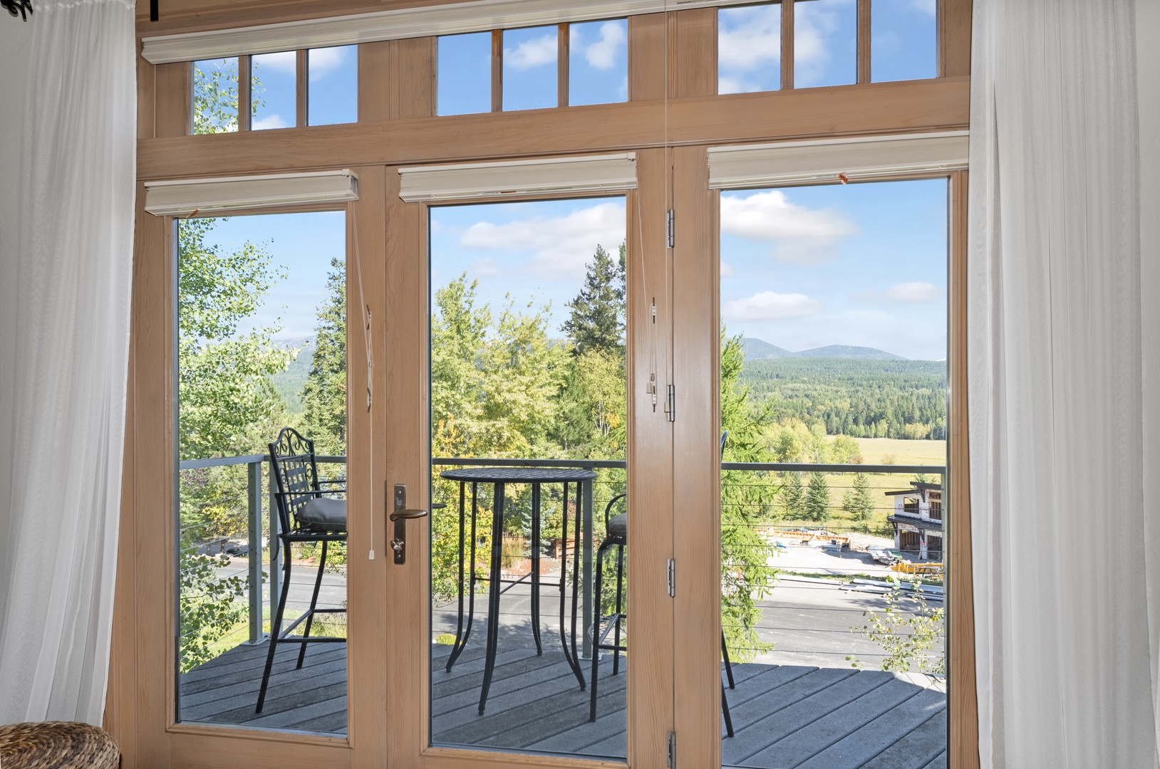 Open these doors to your private balcony and breathe in the mountain air—lush forests and tranquil scenery stretch before you, inviting quiet mornings with coffee and peaceful evenings under the sky.